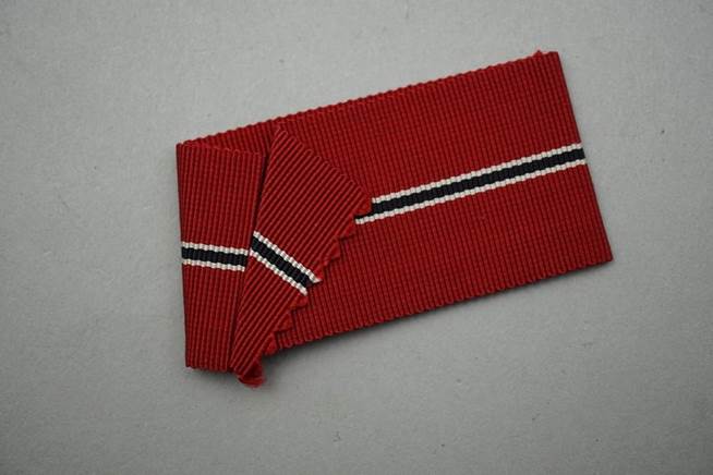 A red and black striped fabric

Description automatically generated