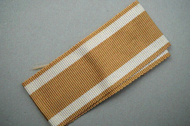 A brown and white striped ribbon

Description automatically generated