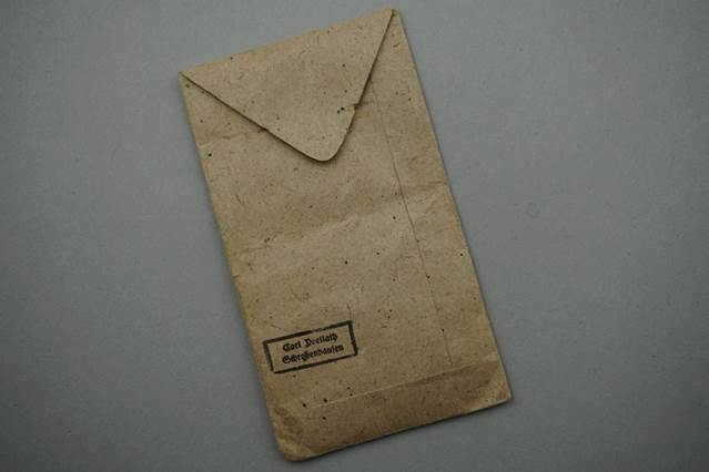 A brown envelope with a stamp on it

Description automatically generated