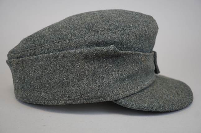 A grey hat with a button

Description automatically generated