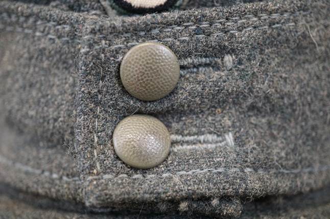 Close-up of a button on a piece of clothing

Description automatically generated