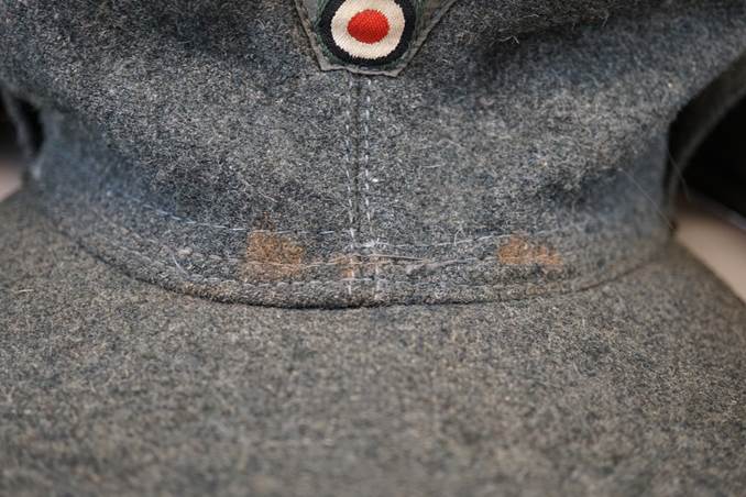 Close-up of a hat with a patch on the front

Description automatically generated