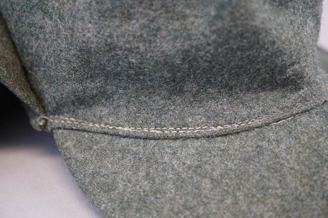 A close-up of a grey hat

Description automatically generated