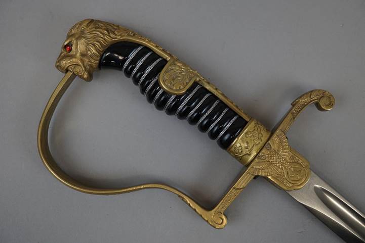 A sword with a lion head handle

Description automatically generated