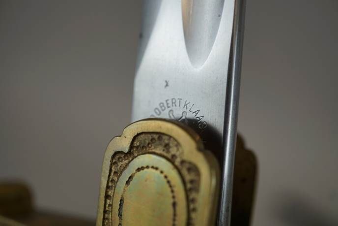 Close-up of a knife's handle

Description automatically generated