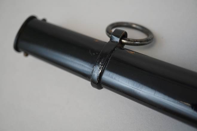 Close-up of a black pipe

Description automatically generated