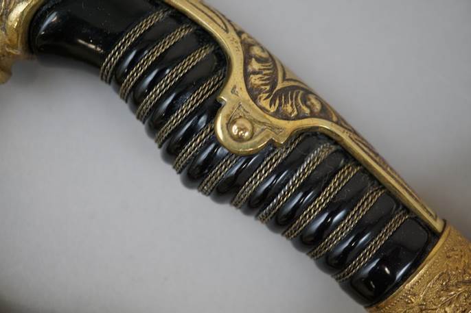 A close-up of a sword handle

Description automatically generated