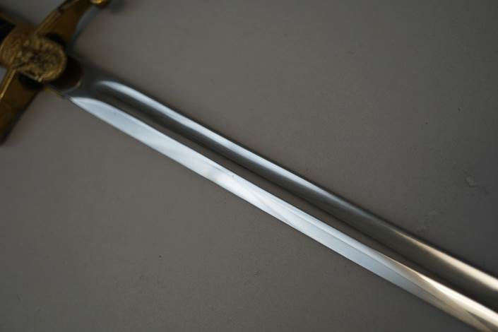 A close-up of a sword

Description automatically generated