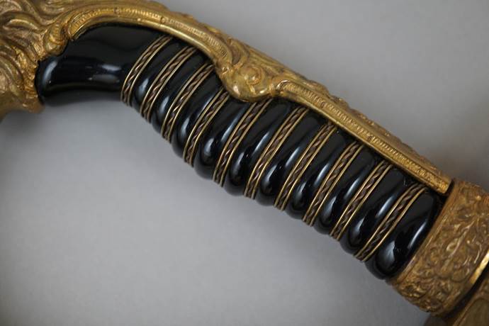 Close-up of a sword handle

Description automatically generated