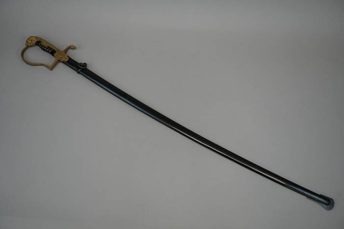 A sword with a gold handle

Description automatically generated