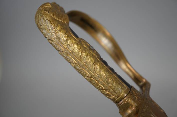 Close-up of a handle of a sword

Description automatically generated
