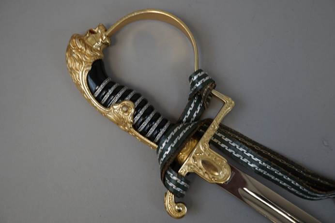 A sword with a handle tied to it

Description automatically generated