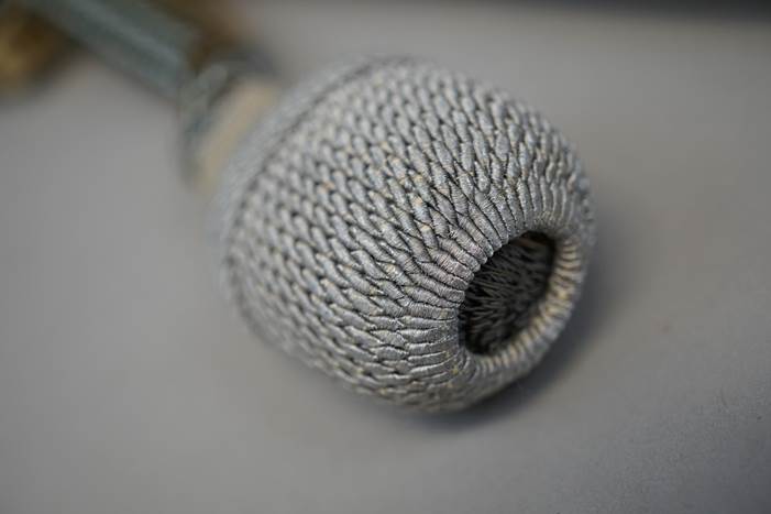 A close-up of a microphone

Description automatically generated