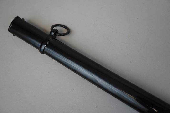 A black metal tube with a ring

Description automatically generated