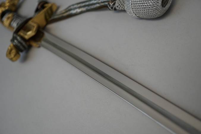 A sword with a string

Description automatically generated