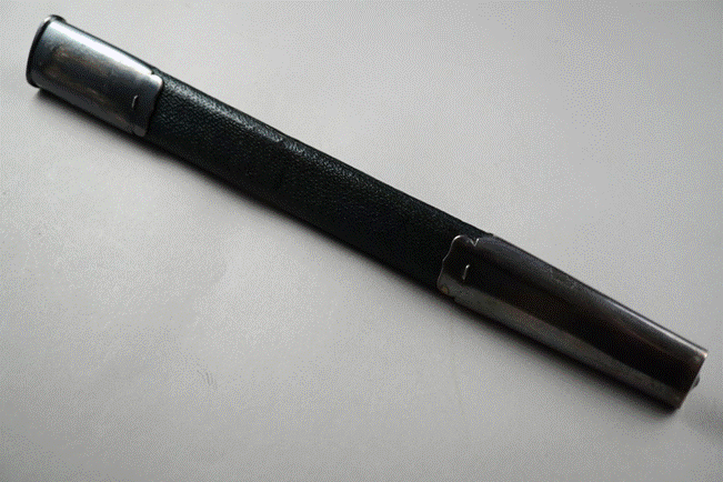A black and silver pen

Description automatically generated