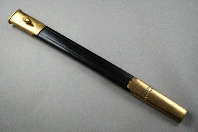 A black and gold sword

Description automatically generated