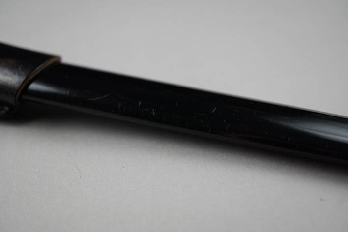 A close up of a pen

Description automatically generated