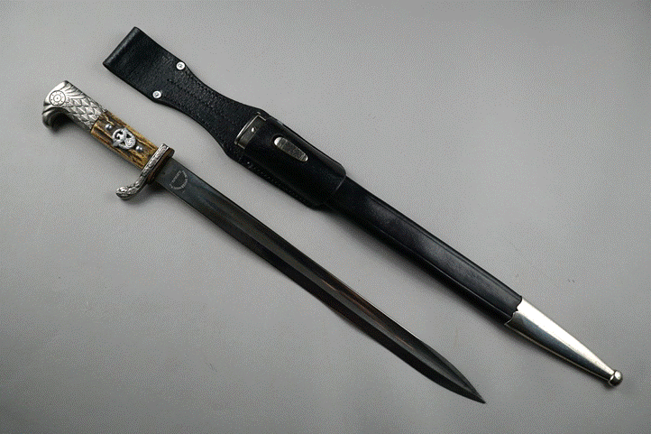 A knife and sheath on a grey surface

Description automatically generated