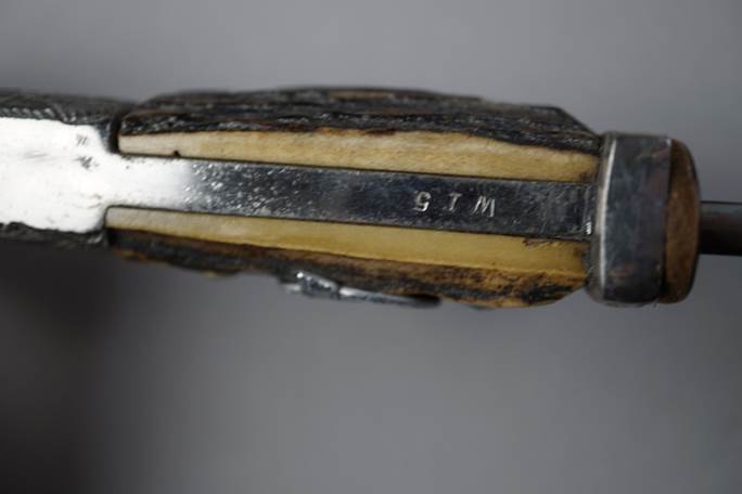 Close-up of a knife handle

Description automatically generated