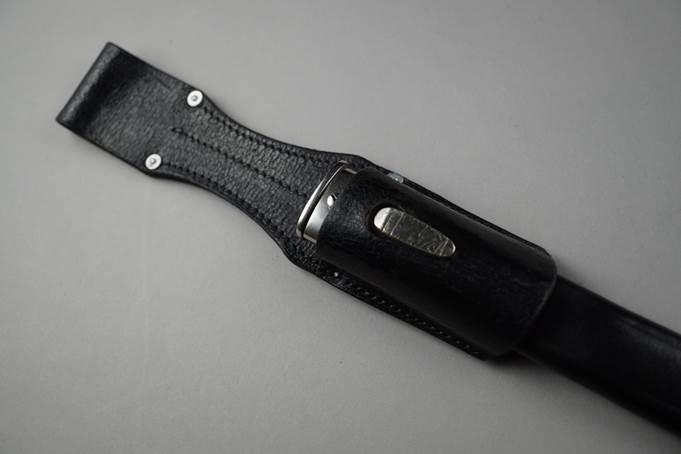 A black leather case with a silver handle

Description automatically generated