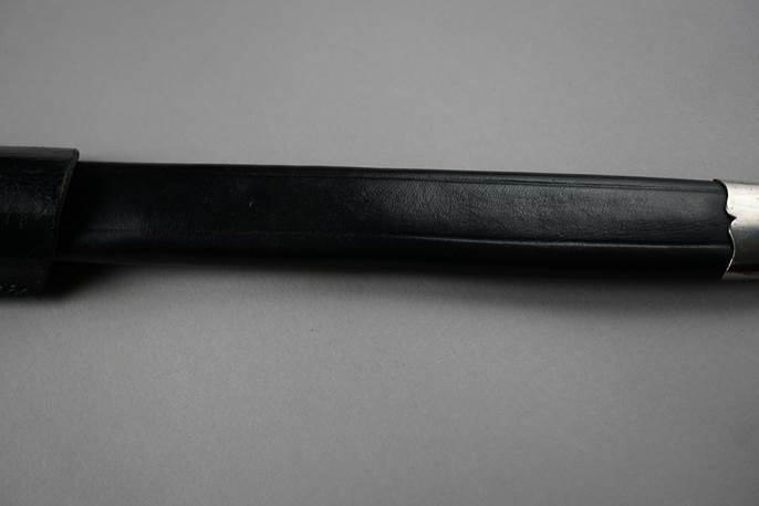 A black tool with a black handle

Description automatically generated