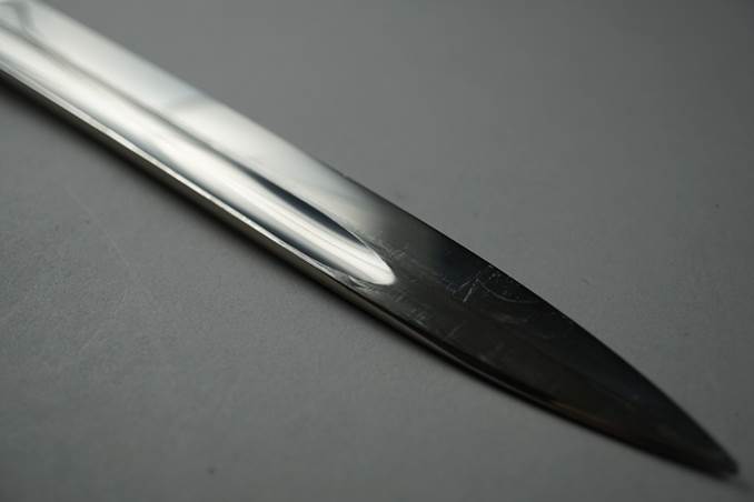 Close-up of a blade of a sword

Description automatically generated