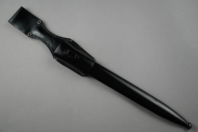 A black knife with a sheath

Description automatically generated
