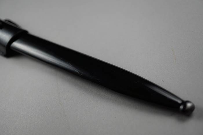 A close-up of a pen

Description automatically generated