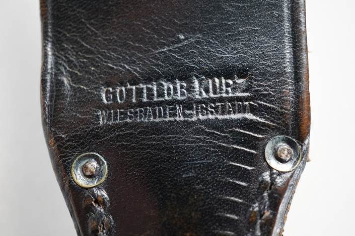 A close-up of a leather holster

Description automatically generated