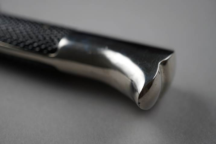 Close-up of a metal handle

Description automatically generated