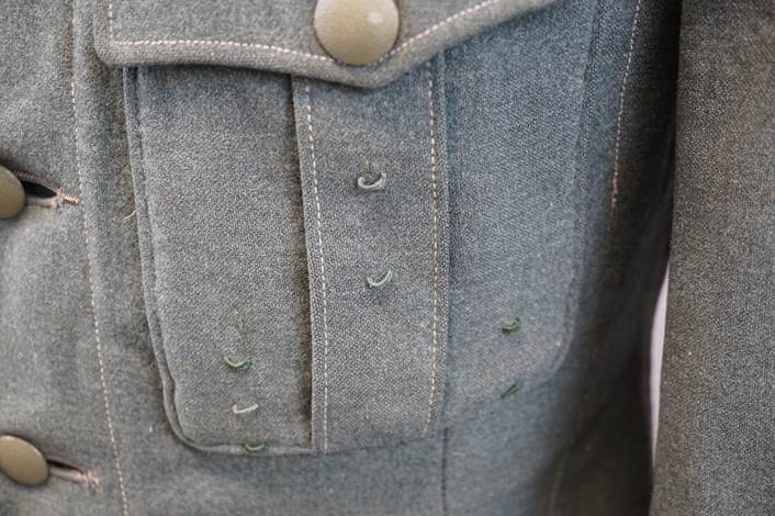 Close-up of a grey jacket pocket

Description automatically generated