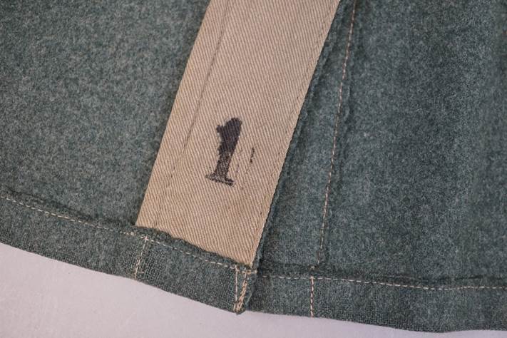 A close-up of a fabric with a number one

Description automatically generated