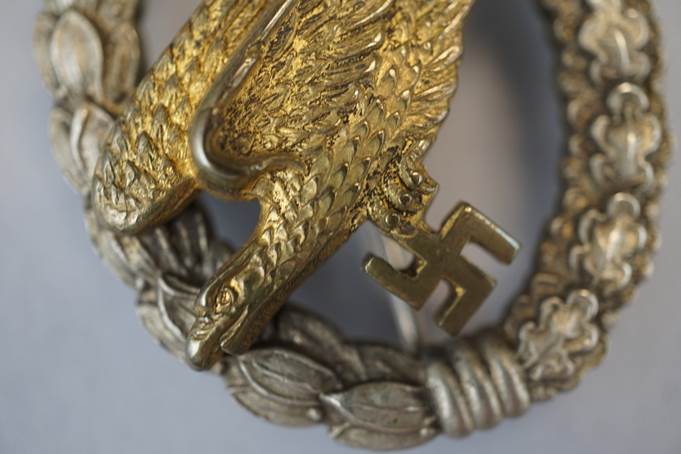 A close-up of a gold eagle with a swastika

Description automatically generated