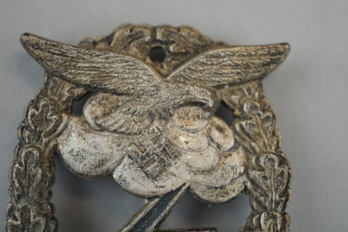 A close-up of a metal emblem

Description automatically generated