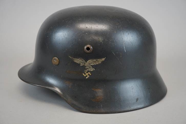 A black helmet with a symbol on it

Description automatically generated