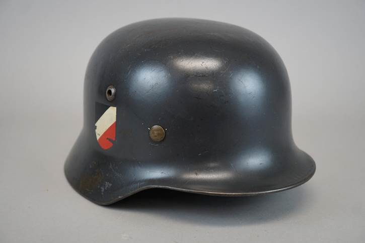 A black helmet with a sticker on it

Description automatically generated