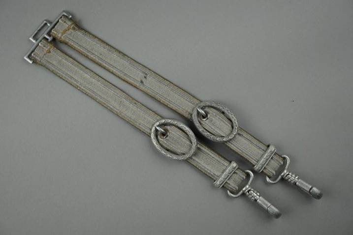 A pair of belts with metal rings

Description automatically generated