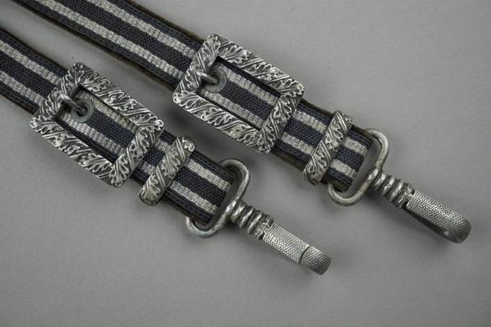 A pair of belts with metal buckles

Description automatically generated