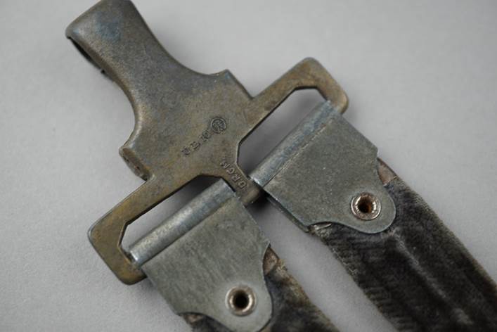 A close-up of a metal buckle

Description automatically generated