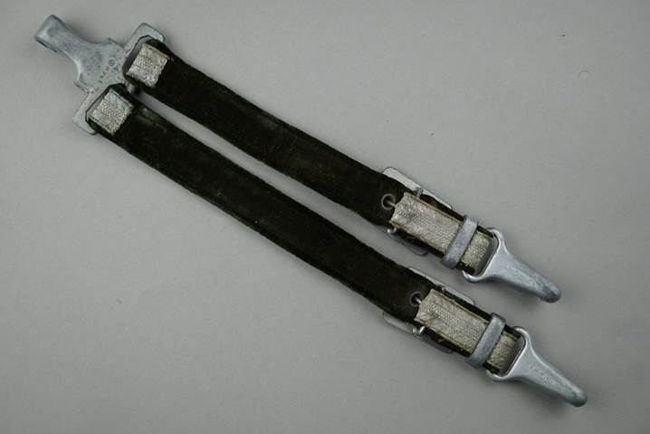 A pair of black straps

Description automatically generated