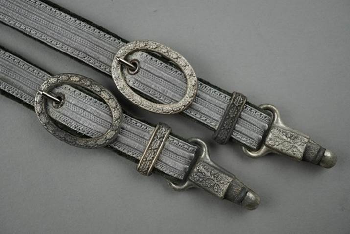 A pair of belts with buckles

Description automatically generated