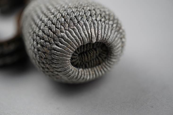 A close-up of a knitted object

Description automatically generated