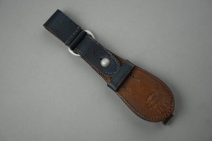 A leather strap with a metal buckle

Description automatically generated