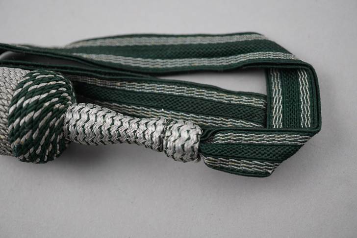 A green and white tie

Description automatically generated