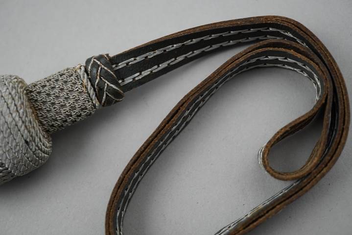 A close-up of a leather strap

Description automatically generated