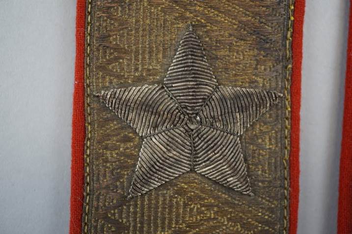 A star on a red fabric

Description automatically generated