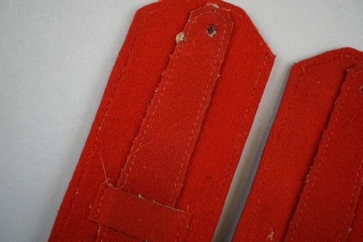 Close-up of a red leather strap

Description automatically generated