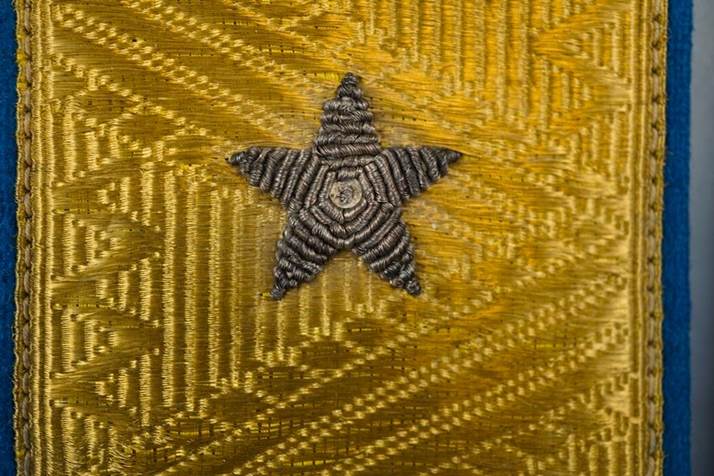 A star on a yellow fabric

Description automatically generated
