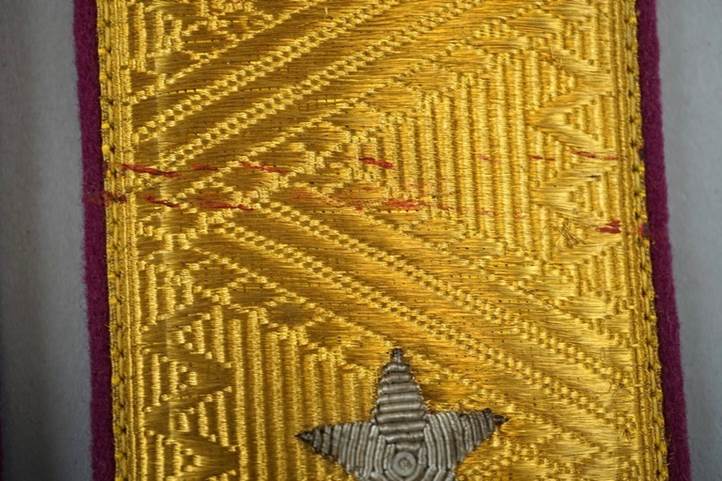 A close-up of a gold fabric

Description automatically generated